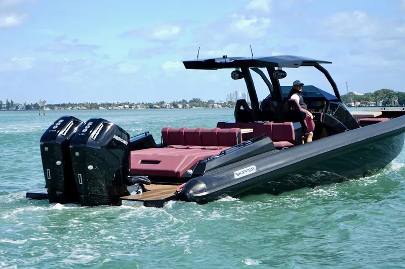 Slide: The Image of 2024 Skipper 42 boat cruising on water with dual engines and sleek design. - 24