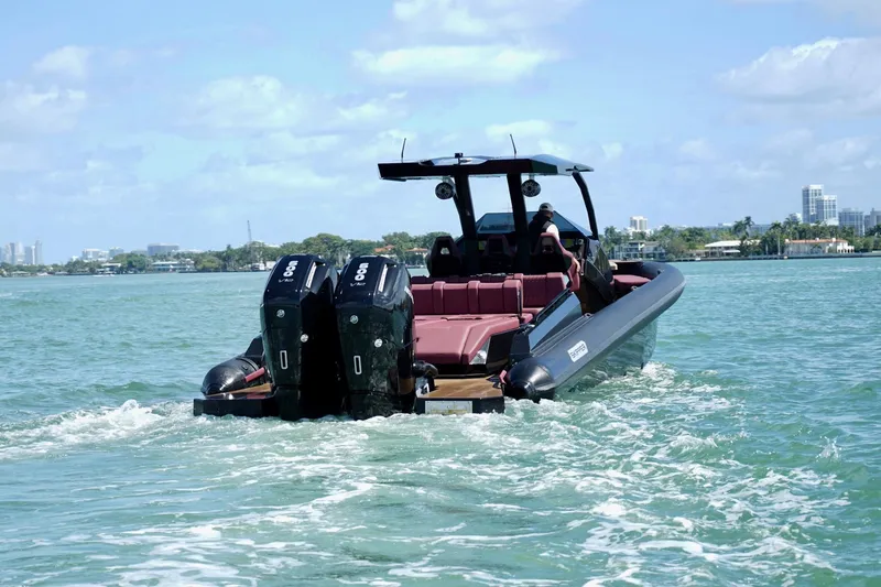 Slide: The Image of 2024 Skipper 42 boat cruising on clear blue water with dual engines. - 26