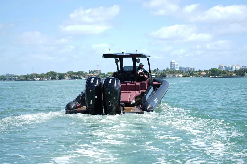 Slide: The Image of 2024 Skipper 42 boat cruising on a sunny day with twin outboard engines. - 27