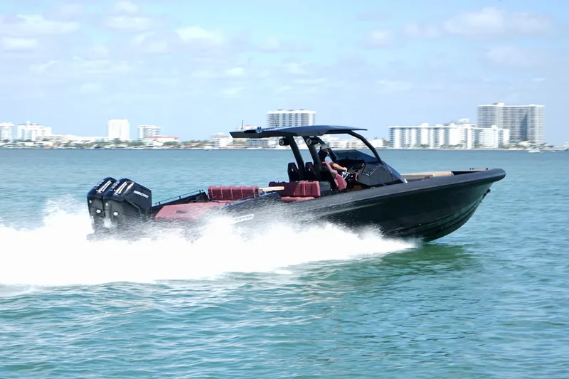 Slide: The Image of 2024 Skipper 42 speedboat cruising on water with city skyline in background. - 35