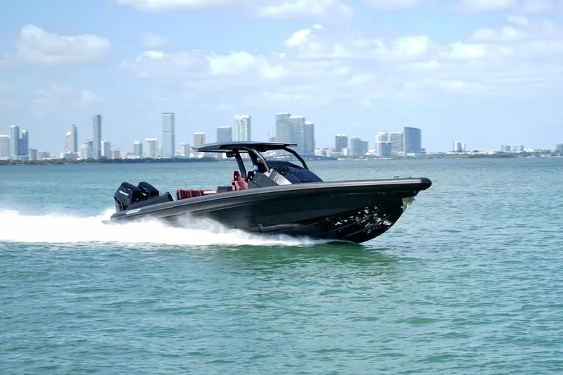 Slide: The Image of 2024 Skipper 42 boat cruising on water with city skyline in background. - 39