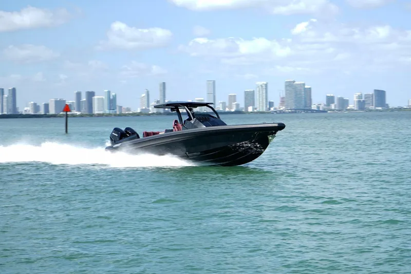 Slide: The Image of 2024 Skipper 42 speedboat cruising on water with city skyline in background. - 41