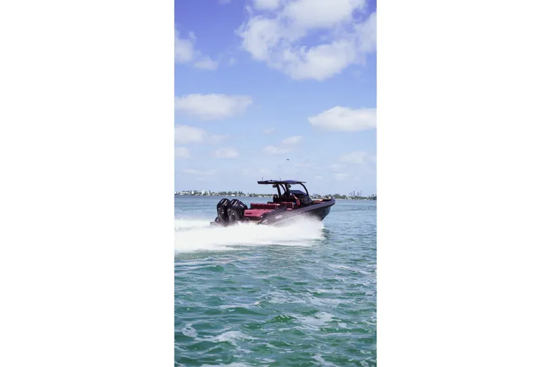 Slide: The Image of 2024 Skipper 42 boat cruising on open water under a clear blue sky. - 44