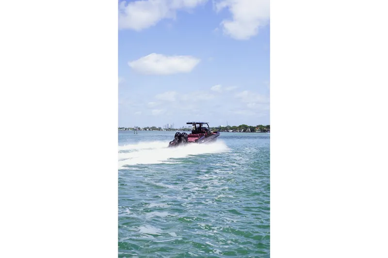 Slide: The Image of 2024 Skipper 42 boat cruising on a sunny day with clear blue skies. - 5