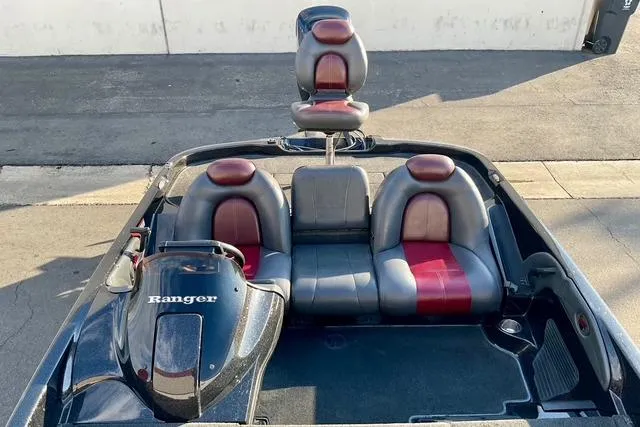 Slide: The Image of 2008 Ranger 188 VX boat interior with red and gray seating, viewed from above. - 12