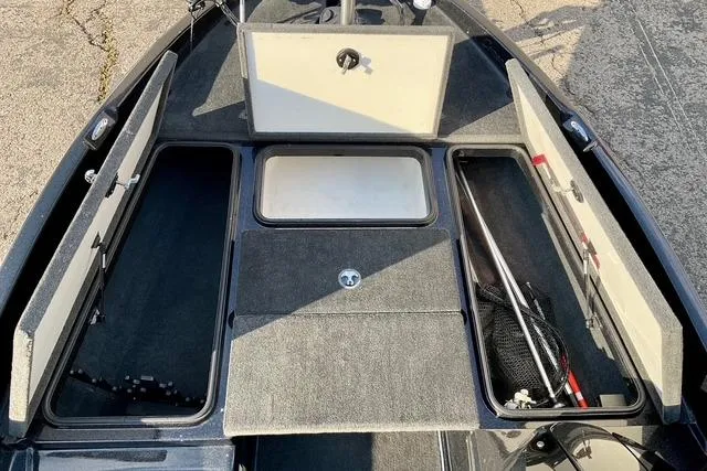 Slide: The Image of 2008 Ranger 188 VX boat interior with open storage compartments and fishing gear. - 19