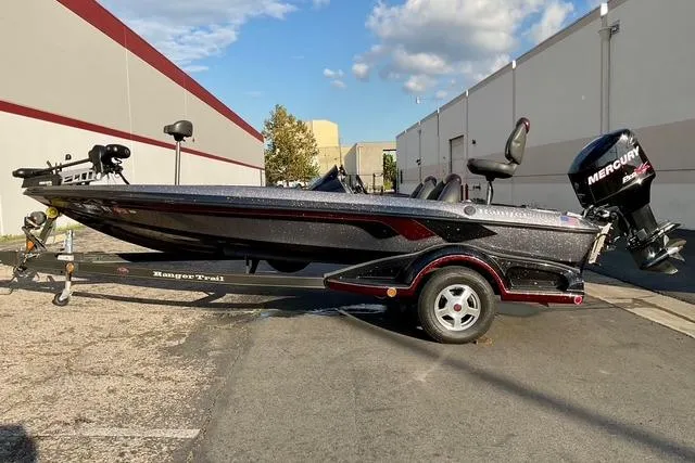 Slide: The Image of 2008 Ranger 188 VX boat with Mercury engine on trailer, parked outdoors. - 5