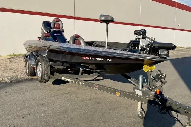 Slide: The Image of 2008 Ranger 188 VX boat on trailer, parked outdoors, featuring sleek black design. - 6