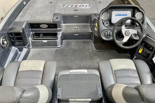 Slide: The Image of 2013 Triton 18XS boat interior with steering wheel and Lowrance electronics. - 10