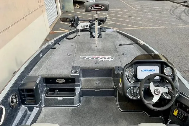 Slide: The Image of 2013 Triton 18XS boat interior with steering console and Lowrance electronics. - 11