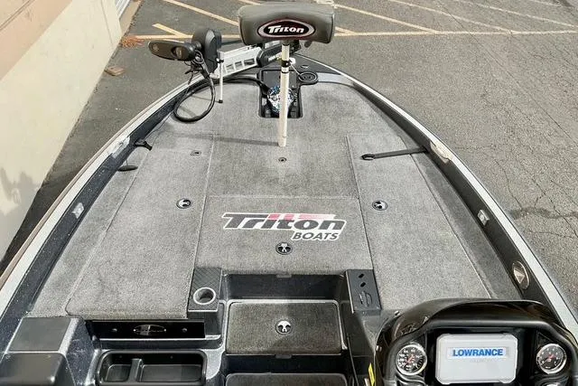 Slide: The Image of 2013 Triton 18XS boat deck with Lowrance electronics and Triton branding. - 15