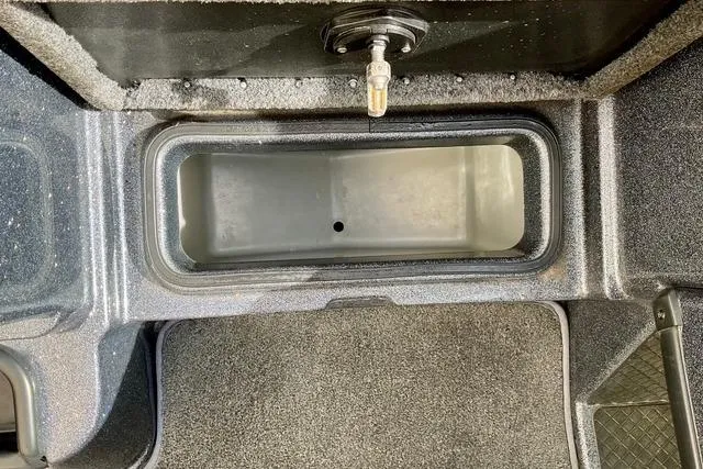 Slide: The Image of Storage compartment in a 2013 Triton 18XS boat, featuring a durable interior design. - 17