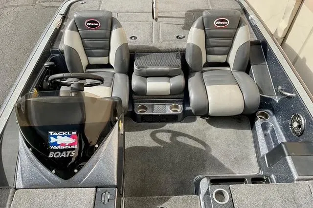 Slide: The Image of 2013 Triton 18XS boat interior with dual seats and steering console. - 19