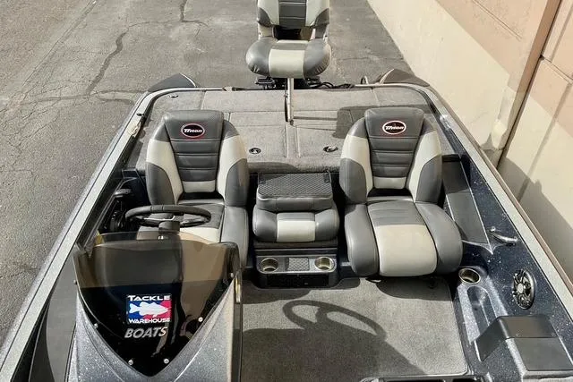 Slide: The Image of 2013 Triton 18XS boat interior with dual seats and steering console. - 20