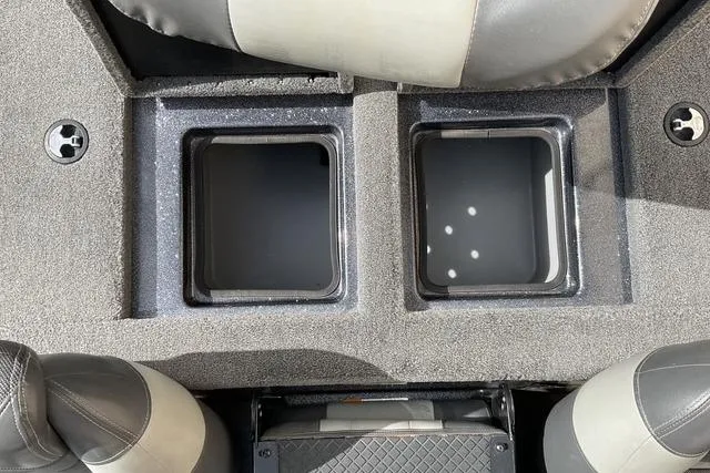 Slide: The Image of 2013 Triton 18XS boat interior with dual storage compartments and seating. - 23