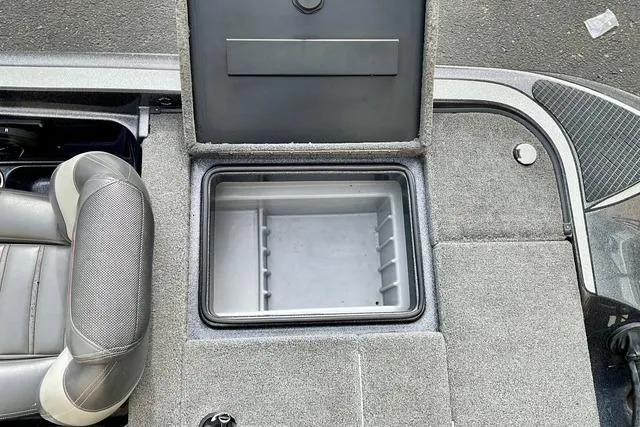 Slide: The Image of 2013 Triton 18XS boat interior with open storage compartment and seating. - 25