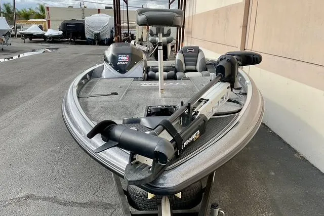 Slide: The Image of 2013 Triton 18XS fishing boat with Minn Kota trolling motor, parked outdoors. - 5