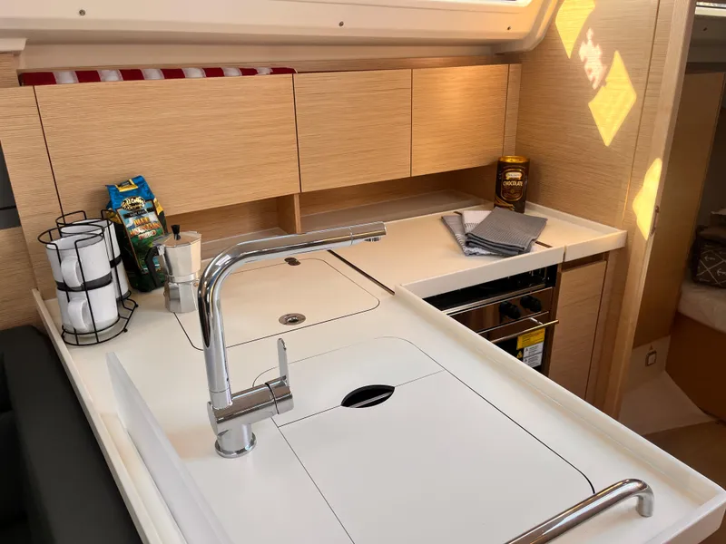 Slide: The Image of Modern kitchen area in 2026 Hanse 348 yacht, featuring sleek cabinetry and stainless steel fixtures. - 19