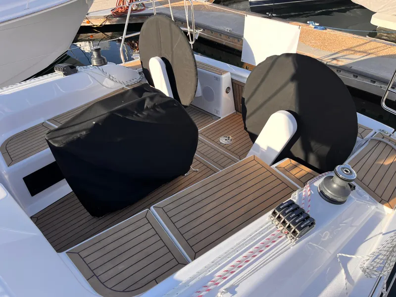 Slide: The Image of 2026 Hanse 348 yacht cockpit with covered steering wheels and teak flooring. - 2