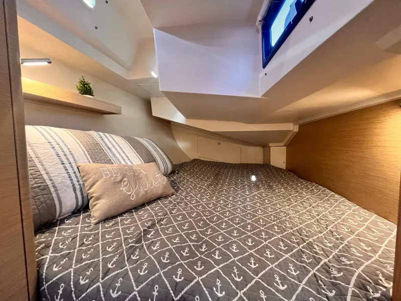 Slide: The Image of Cozy cabin interior of 2026 Hanse 348 yacht with nautical-themed bedding. - 28