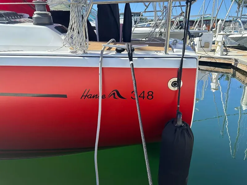 Slide: The Image of Red Hanse 348 sailboat docked in marina, 2026 model. - 32