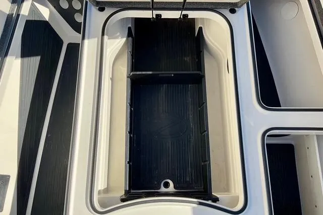 Slide: The Image of 2020 Ranger Z520L boat storage compartment with black interior. - 11