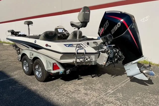 Slide: The Image of 2020 Ranger Z520L boat with powerful outboard motor, parked on a trailer. - 3