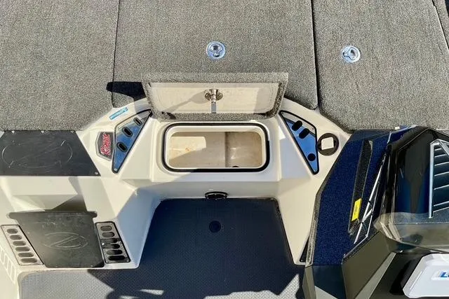 Slide: The Image of 2020 Ranger Z520L boat deck with storage compartment and carpeted surface. - 9