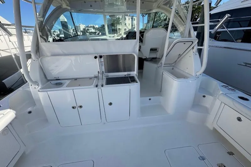 Slide: The Image of 2021 Pursuit OS 385 Offshore boat interior with seating and storage compartments. - 13