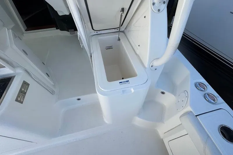 Slide: The Image of 2021 Pursuit OS 385 Offshore boat interior with open storage compartment. - 14