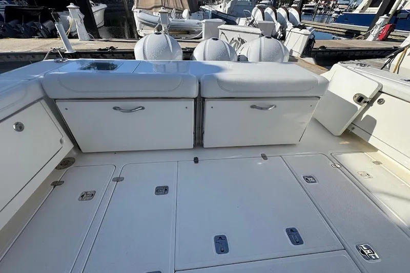 Slide: The Image of 2021 Pursuit OS 385 Offshore boat deck with storage compartments and seating. - 15