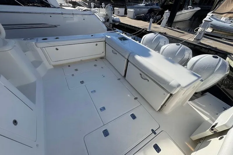 Slide: The Image of 2021 Pursuit OS 385 Offshore boat deck with storage compartments and outboard motors. - 16