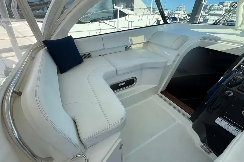 Slide: The Image of 2021 Pursuit OS 385 Offshore boat interior with white seating and blue cushion. - 18