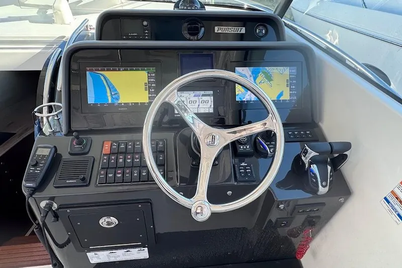 Slide: The Image of Control panel of 2021 Pursuit OS 385 Offshore boat with navigation screens and steering wheel. - 20