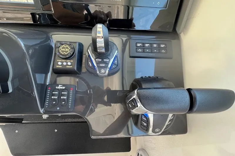 Slide: The Image of Control panel of 2021 Pursuit OS 385 Offshore boat with throttle and navigation controls. - 22