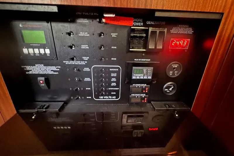 Slide: The Image of Electrical control panel of a 2021 Pursuit OS 385 Offshore boat, displaying various switches and gauges. - 29
