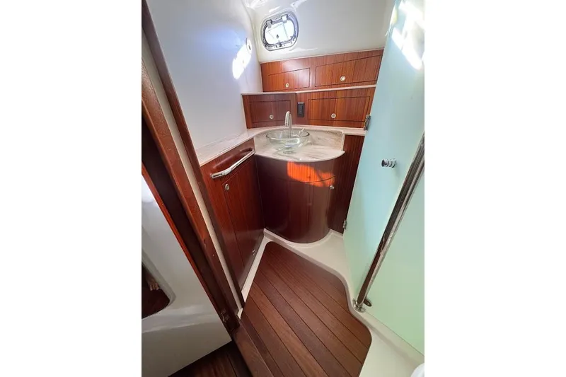 Slide: The Image of 2021 Pursuit OS 385 Offshore yacht bathroom with wood cabinetry and modern sink. - 30