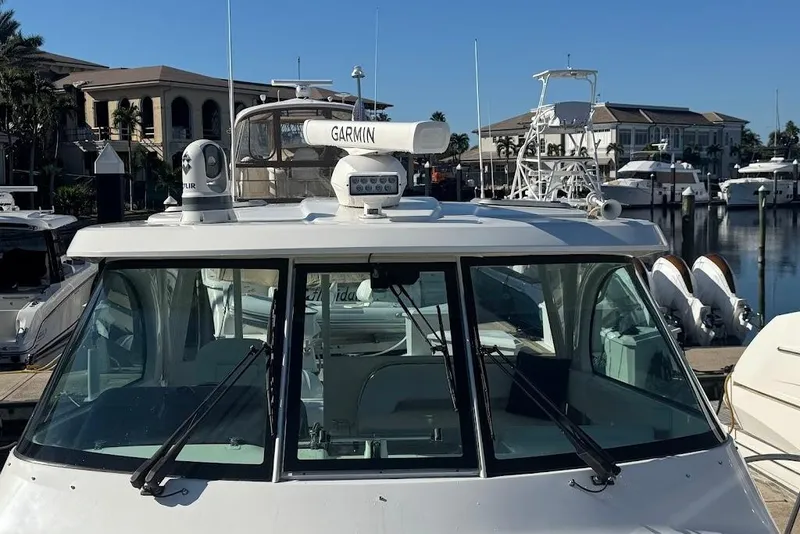Slide: The Image of 2021 Pursuit OS 385 Offshore boat docked at marina with Garmin equipment. - 34