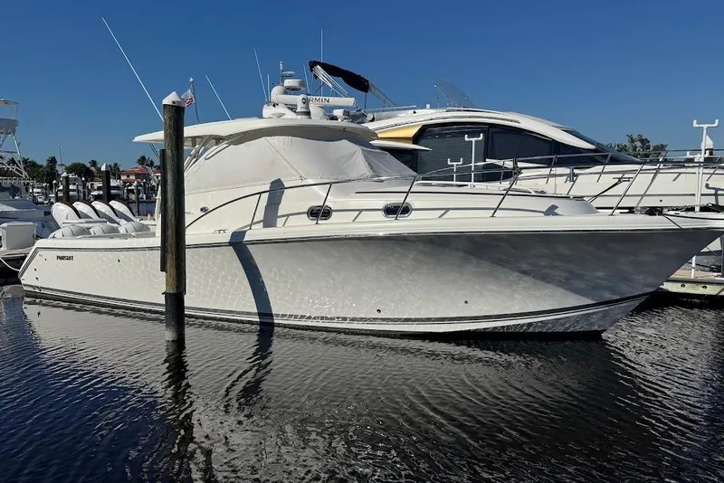 Slide: The Image of 2021 Pursuit OS 385 Offshore boat docked in marina under clear blue sky. - 39