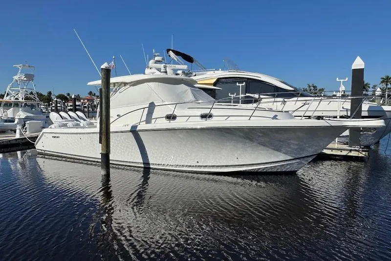 Slide: The Image of 2021 Pursuit OS 385 Offshore boat docked in marina under clear blue sky. - 40