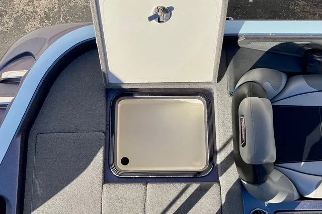 Slide: The Image of 2015 Ranger Z518 Comanche boat interior with open storage compartment and seating. - 10