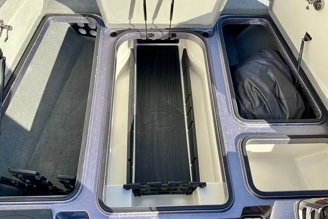 Slide: The Image of 2015 Ranger Z518 Comanche boat storage compartments, open and empty, showcasing interior layout. - 12