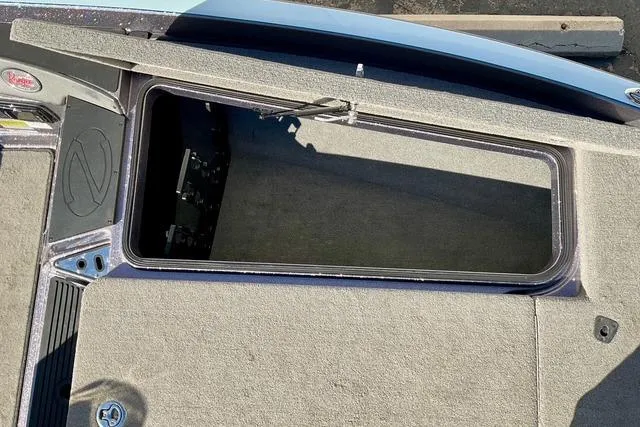 Slide: The Image of 2015 Ranger Z518 Comanche boat storage compartment with open lid, showing interior space. - 13