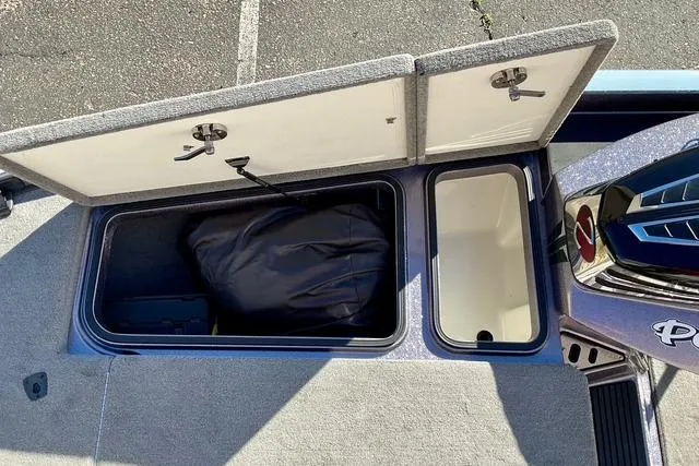 Slide: The Image of Open storage compartments on a 2015 Ranger Z518 Comanche boat. - 14