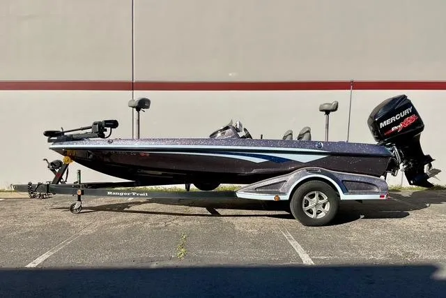 Slide: The Image of 2015 Ranger Z518 Comanche bass boat on trailer, parked outdoors. - 2