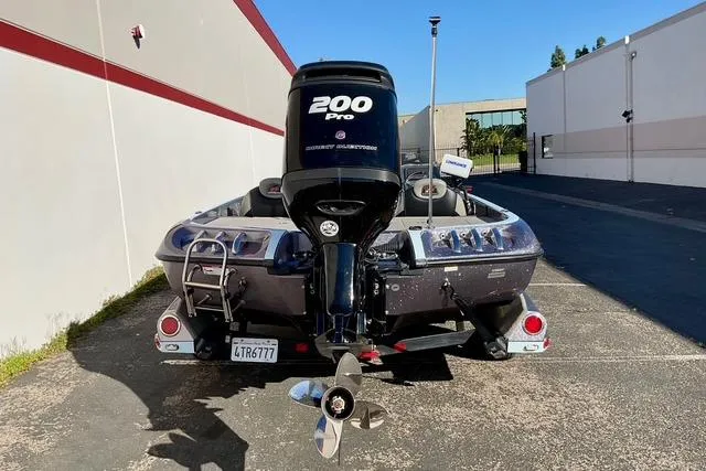 Slide: The Image of 2015 Ranger Z518 Comanche boat with 200 Pro Mercury outboard motor, parked outdoors. - 20