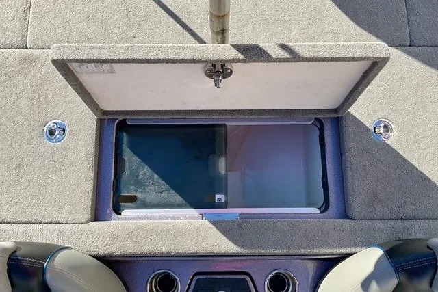 Slide: The Image of 2015 Ranger Z518 Comanche boat storage compartment with open lid, showcasing interior details. - 8