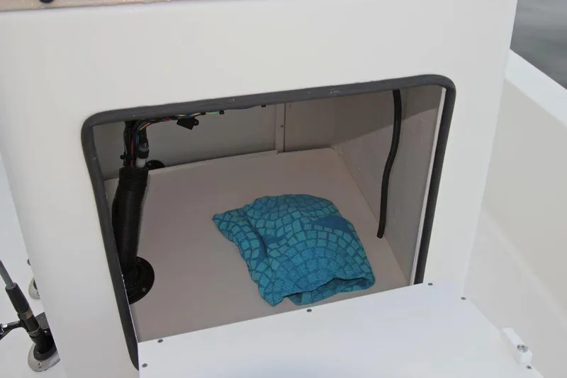 Slide: The Image of Manufacturer Provided Image: Storage compartment of 2019 Cobia 21 Bay boat with a blue towel inside. - 18