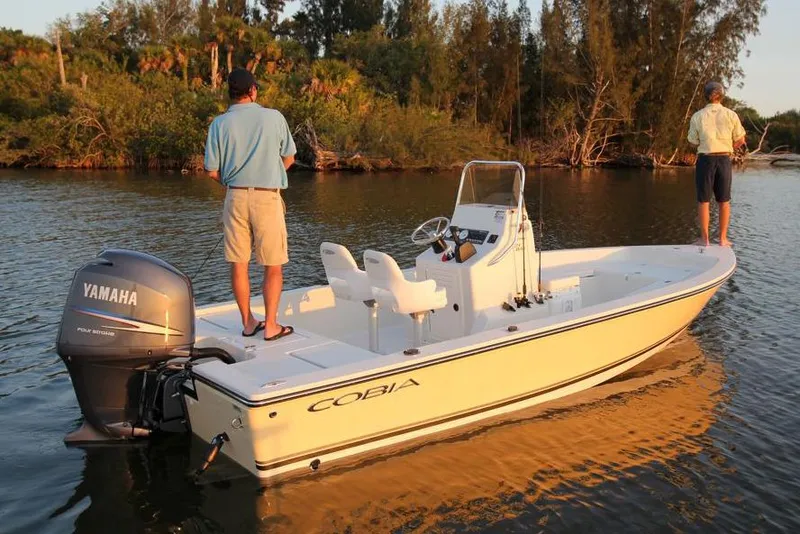 Slide: The Image of Manufacturer Provided Image: 2019 Cobia 21 Bay boat with Yamaha outboard motor on calm water. - 5