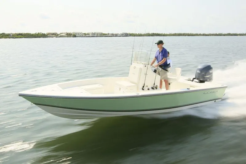 Slide: The Image of Manufacturer Provided Image: 2019 Cobia 21 Bay boat cruising on calm water. - 8